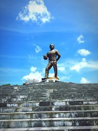 Low angle view of statue against blue sky