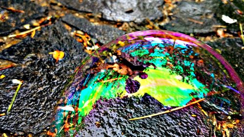 High angle view of multi colored pencils on rock