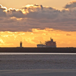 Lighthouse at seaside during sunset