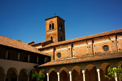 Low angle view of historic churc against clear blue sky