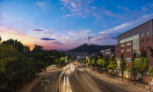 High angle view of illuminated street against sky during sunset