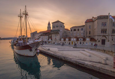 Boats in river at sunset