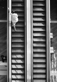 Low section of person on escalator