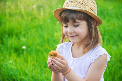 Portrait of young woman standing on field