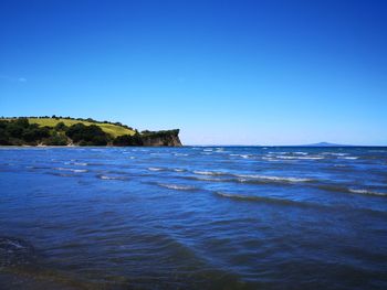 Scenic view of sea against clear blue sky