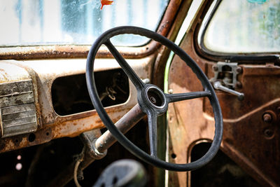 Close-up of rusty steering wheel in old car