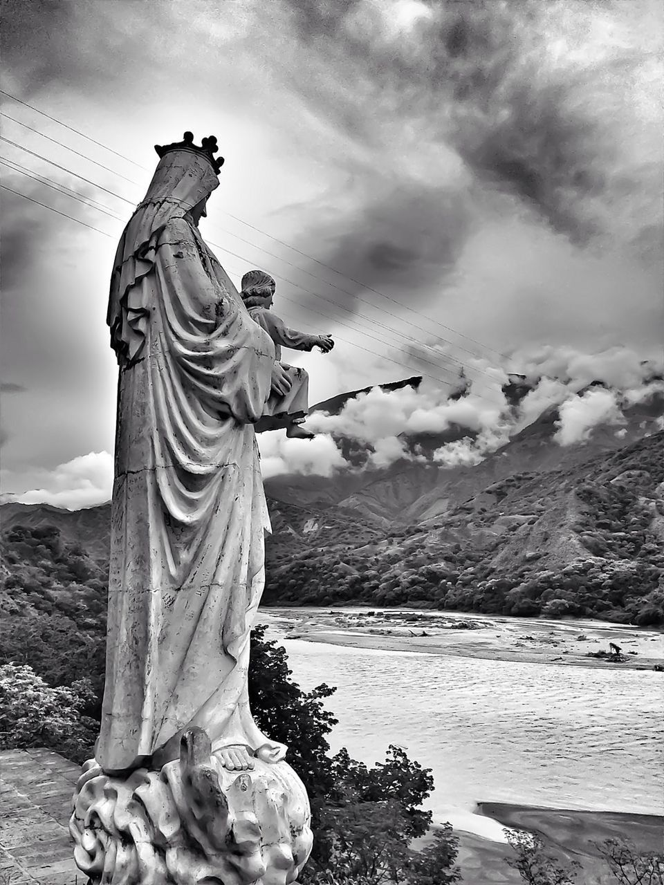 statue, human representation, sculpture, art and craft, art, sky, creativity, cloud - sky, cloudy, water, cloud, animal representation, tranquility, day, religion, nature, outdoors, mountain