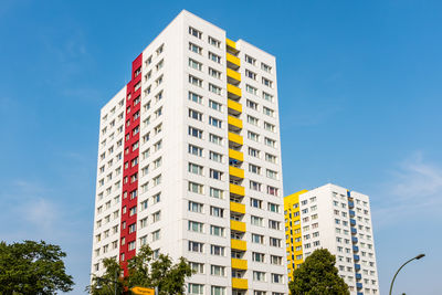 Low angle view of buildings against clear blue sky