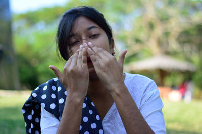 Portrait of beautiful young woman with eyes closed