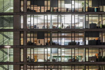 Germany, baden-wurttemberg, stuttgart, exterior of illuminated office building at night