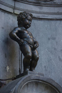 Low angle view of statue against wall