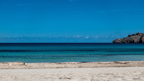 Scenic view of sea against clear blue sky