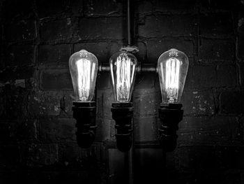 Illuminated light bulb on wall