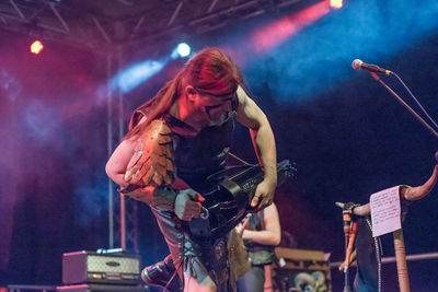 Full length of young woman in music concert