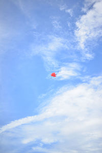 Low angle view of kite flying against blue sky