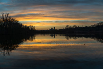 Scenic view of lake against orange sky