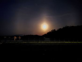 Scenic view of silhouette field against sky at night