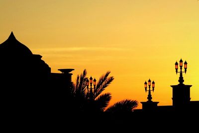 Silhouette built structure at sunset