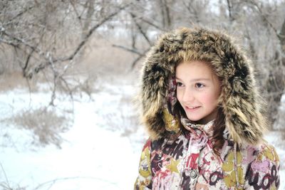 Portrait of smiling girl wearing warm clothing during winter