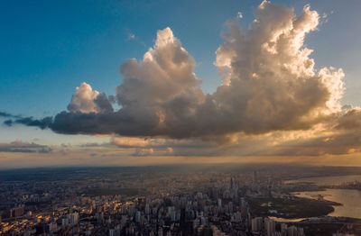 High angle view of buildings against cloudy sky