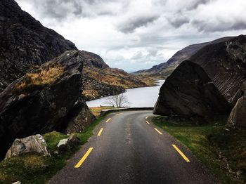 Road amidst mountains against sky