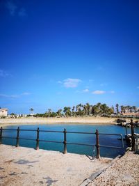 Scenic view of beach against blue sky