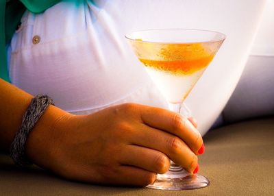 Cropped image of woman hand holding martini glass