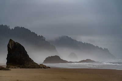 Panoramic view of sea and mountains against sky