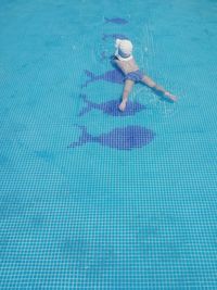 Low section of woman swimming in pool