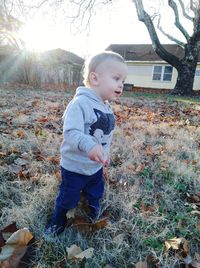 Cute boy looking away on field
