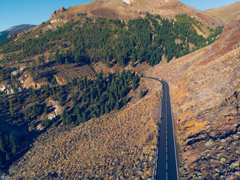 High angle view of road amidst trees and mountains