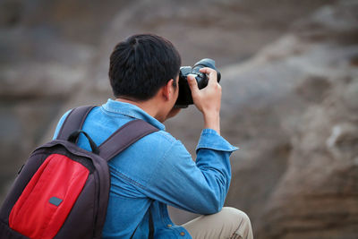 Rear view of man photographing