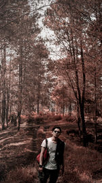 Full length of woman standing in forest