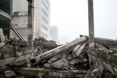 Abandoned buildings against sky in city