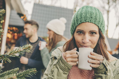 Woman having a hot punch on the christmas market