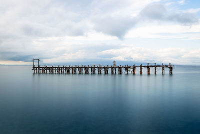 Pier over sea against sky