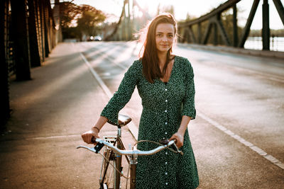 Portrait of young woman riding bicycle