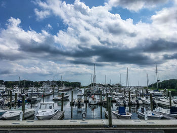 View of harbor against cloudy sky