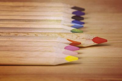 Close-up of multi colored pencils on table