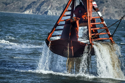 Dredger crane operating in sea