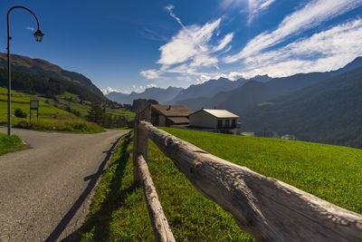 Road leading towards mountains against sky