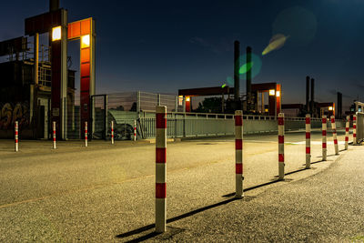 Illuminated street lights in city at night