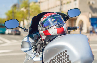 Close-up of motor scooter on road