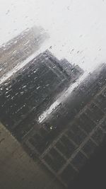 Close-up of wet airplane against sky during rainy season