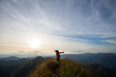 Man standing on mountain against sky