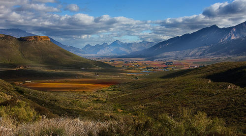 Scenic view of mountains against cloudy sky