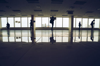 Silhouette people walking in airport