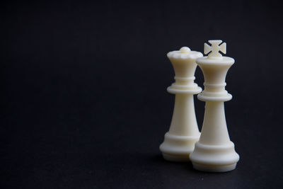 Close-up of chess pieces against black background