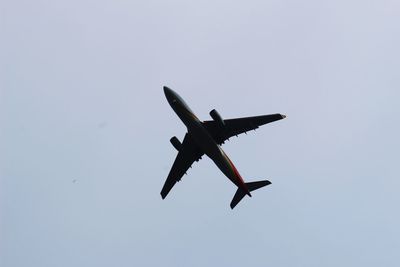 Low angle view of airplane flying in sky
