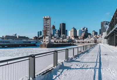 Bridge over river against clear blue sky